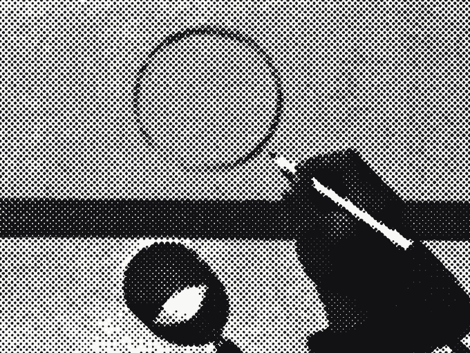 A hand drawing a careful circle in pencil beside a steel ruler and a loupe, the page being corrected by hand