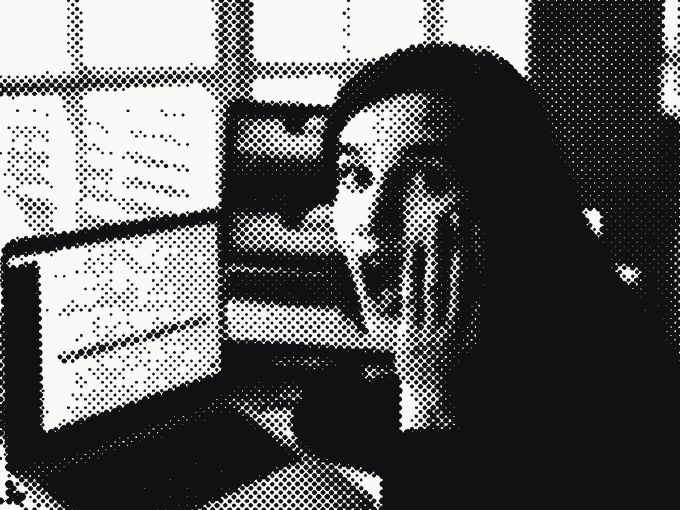 A founder at their desk, hand to cheek, stunned by what their laptop screen is showing them